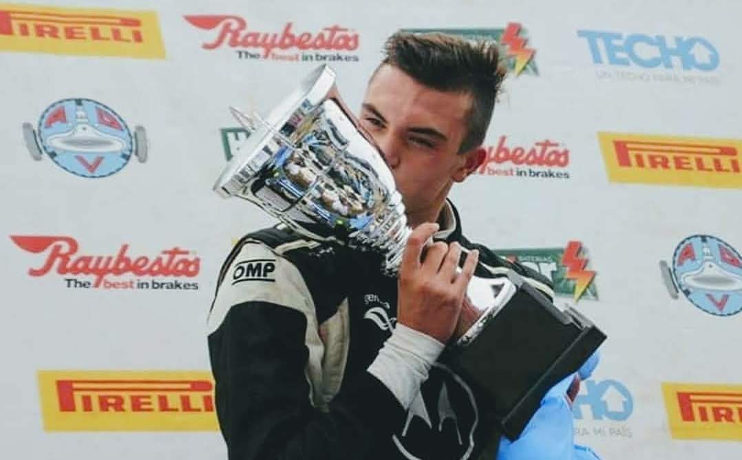 Besando el trofeo tras la victoria